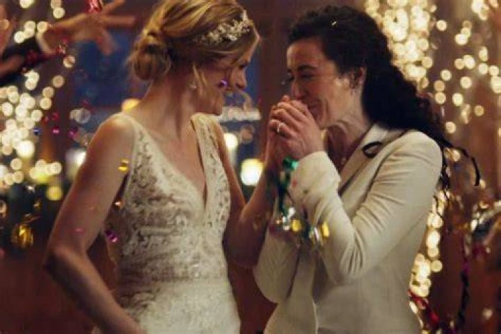 Hallmark Under Fire For Pulling LGBTQ Zola Commerical That Shows Two Lesbian Brides Kissing — Boycott Under Way