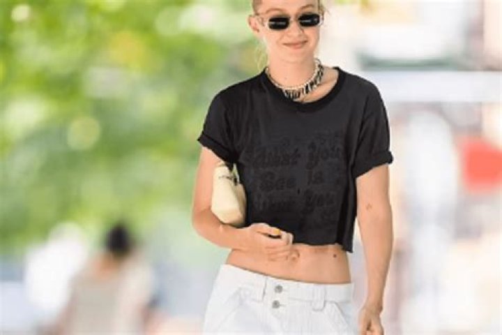In A Low-Rise Pair Of White Slacks And A Black Crop Top, Gigi Hadid Appeared Beautiful And Carefree